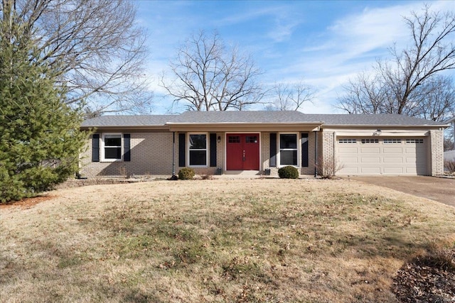 single story home featuring a front lawn, brick siding, concrete driveway, and an attached garage