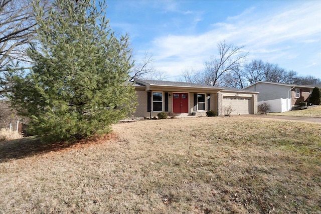 view of front of house with a garage and a front lawn