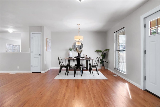 dining space with light wood-type flooring