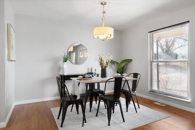 dining area with hardwood / wood-style floors