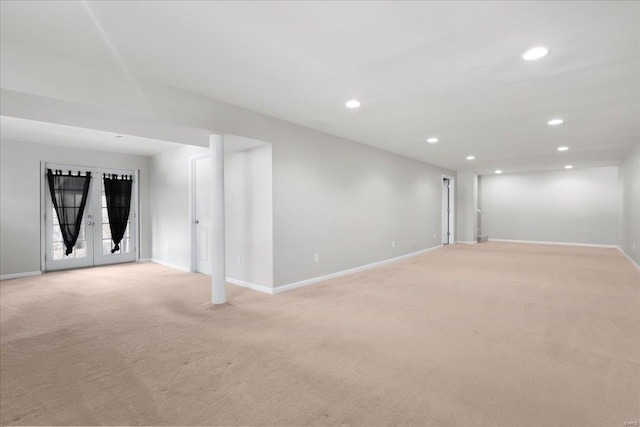 spare room with light colored carpet and french doors