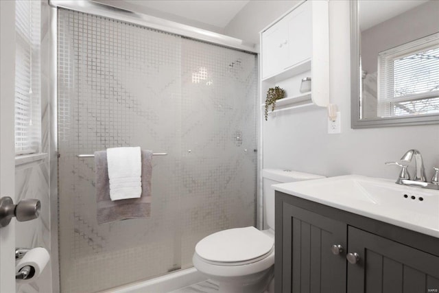 bathroom featuring walk in shower, vanity, and toilet