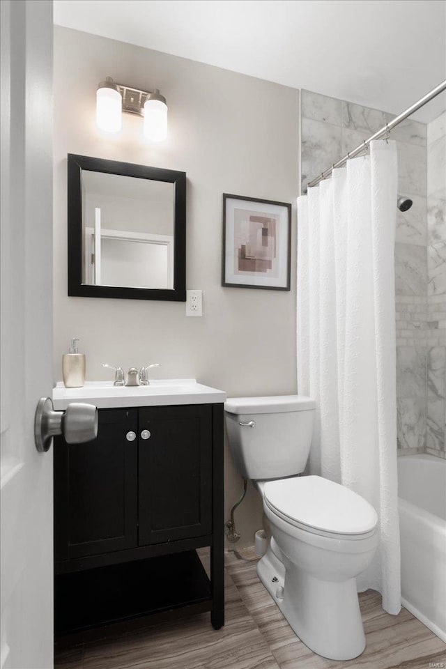 full bathroom featuring shower / bath combination with curtain, vanity, and toilet