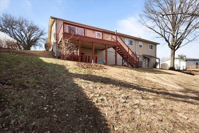 back of house featuring a wooden deck and a yard