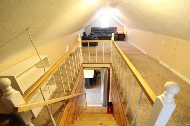 staircase featuring vaulted ceiling