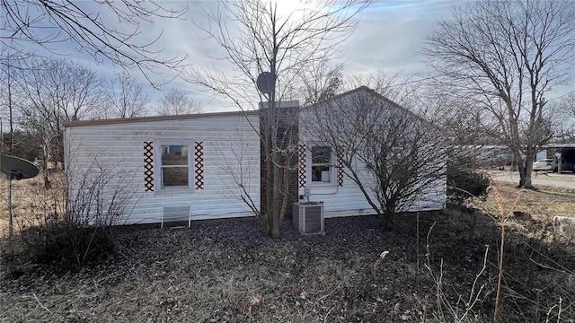 back of house featuring central air condition unit