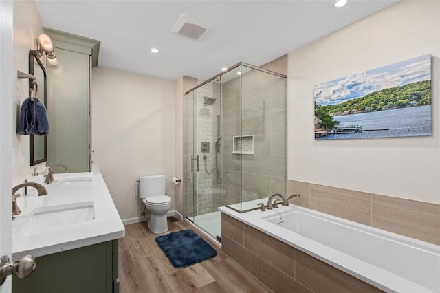 full bathroom with hardwood / wood-style flooring, vanity, separate shower and tub, and toilet