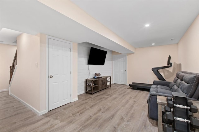 exercise room with light hardwood / wood-style flooring