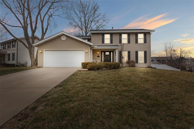 view of front of house with a garage and a lawn