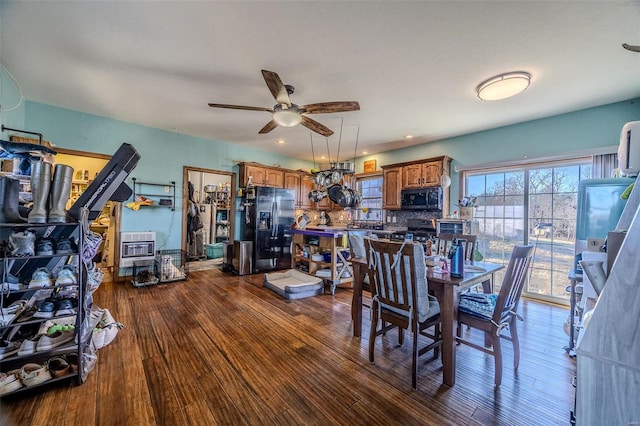 dining room with hardwood / wood-style flooring, ceiling fan, and heating unit