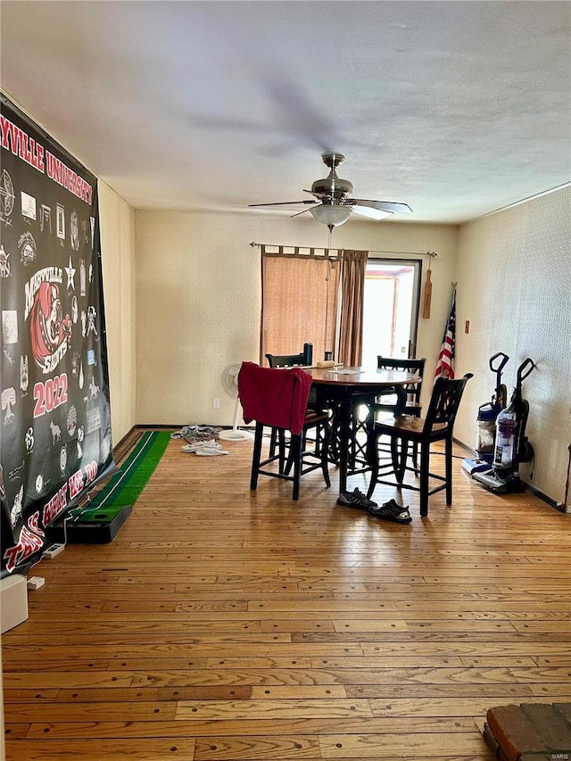 dining space with hardwood / wood-style flooring and ceiling fan