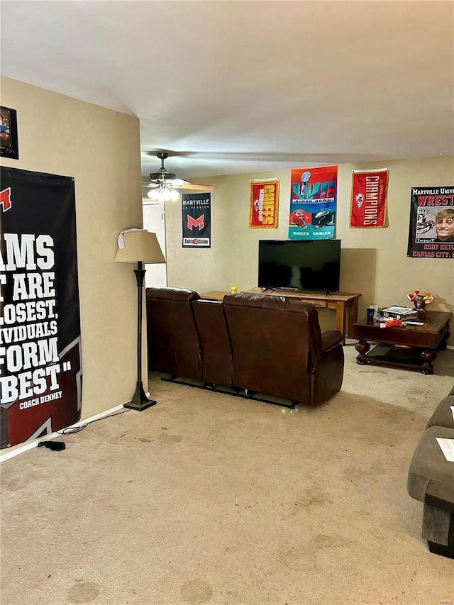 carpeted living room with ceiling fan