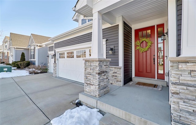 doorway to property with a garage