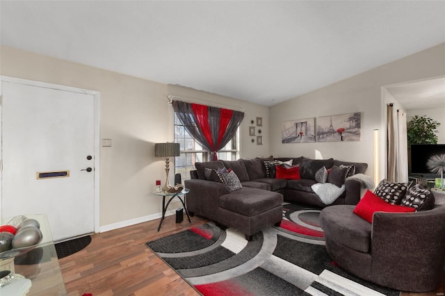 living room featuring lofted ceiling and hardwood / wood-style floors