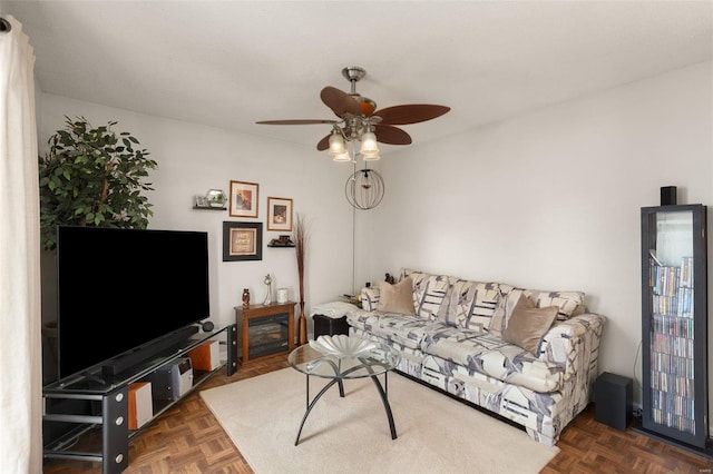 living room featuring dark parquet floors and ceiling fan