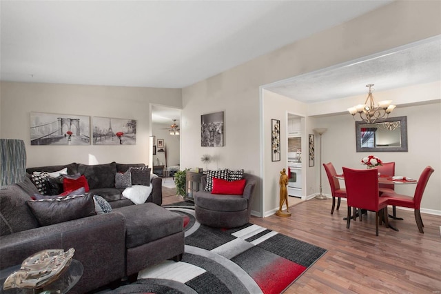 living room with an inviting chandelier and hardwood / wood-style floors