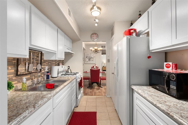 kitchen featuring tasteful backsplash, sink, white appliances, and white cabinets