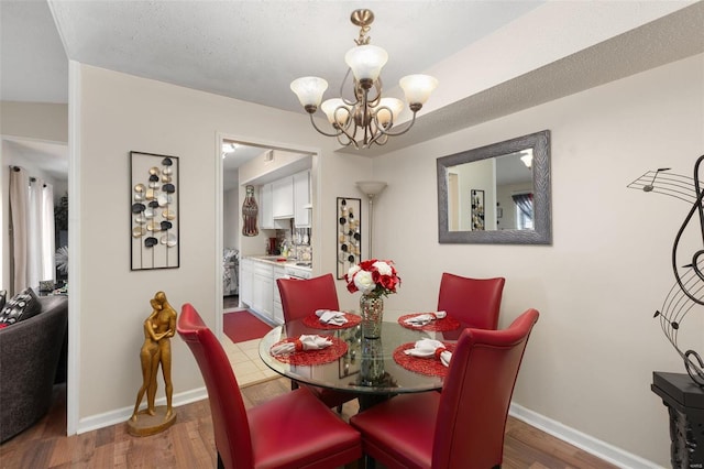 dining room featuring dark wood-type flooring and a chandelier