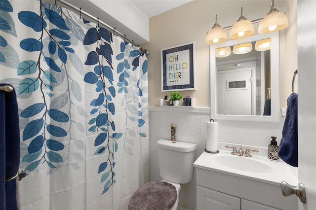 bathroom featuring vanity, toilet, tile walls, and decorative backsplash