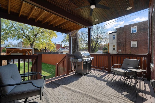 wooden terrace featuring a patio, area for grilling, and ceiling fan