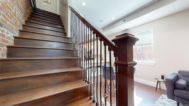 stairs featuring wood-type flooring