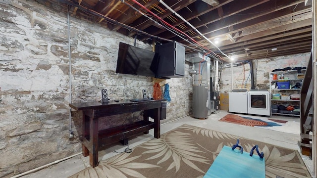 basement with water heater and separate washer and dryer