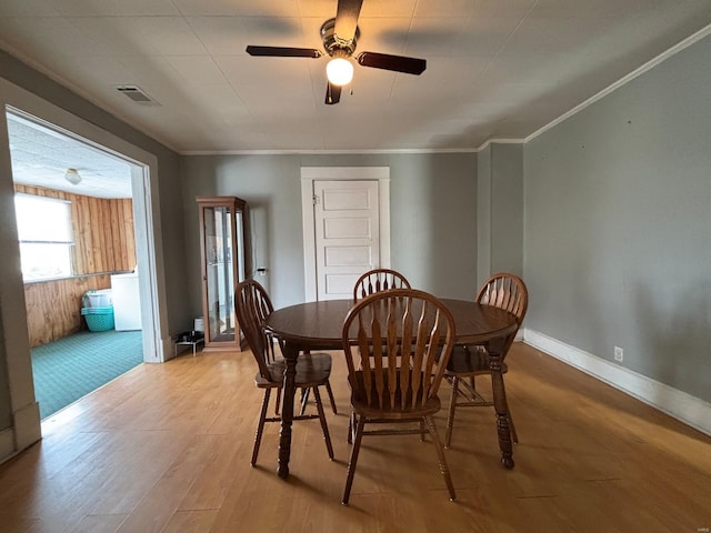 dining space with ornamental molding, light hardwood / wood-style floors, and ceiling fan