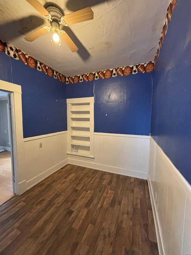 empty room featuring dark hardwood / wood-style flooring and ceiling fan