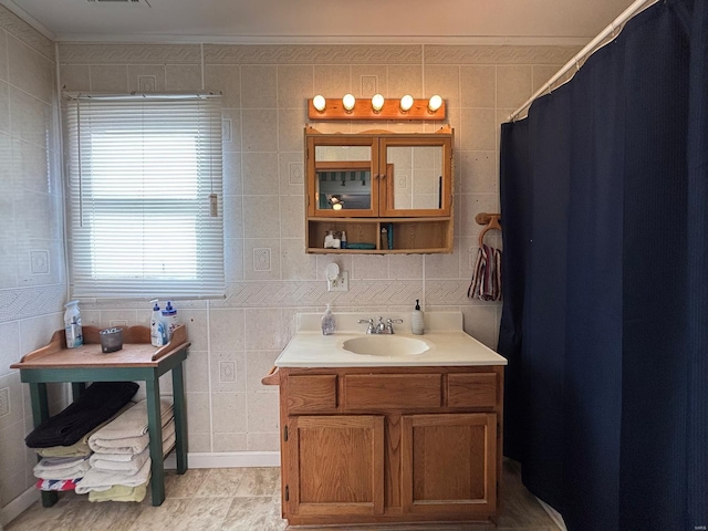 bathroom with tile walls and ornamental molding