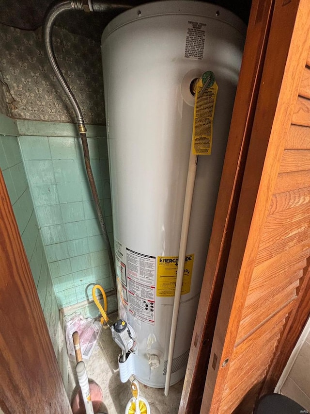 utility room featuring gas water heater