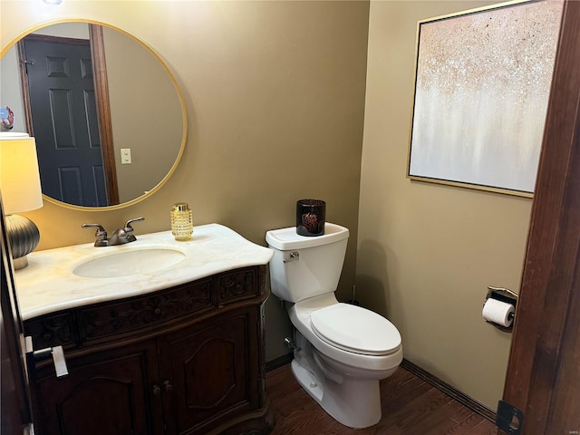 bathroom with wood-type flooring, vanity, and toilet