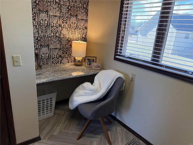 office area featuring parquet floors, built in desk, and a wealth of natural light