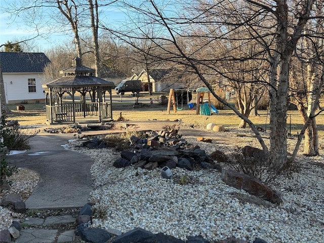 view of yard featuring a gazebo and a playground