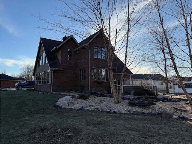 view of side of home featuring a lawn