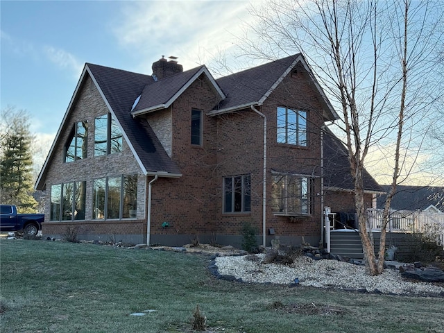 view of side of property with a lawn