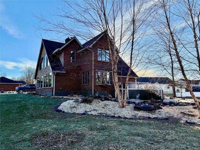 view of side of home with a lawn