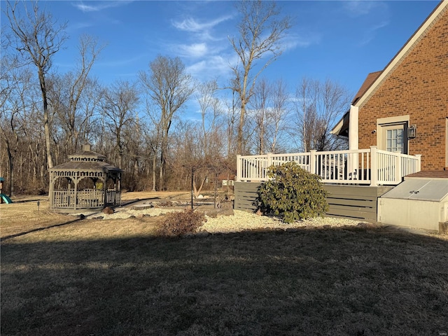 view of yard featuring a wooden deck and a gazebo