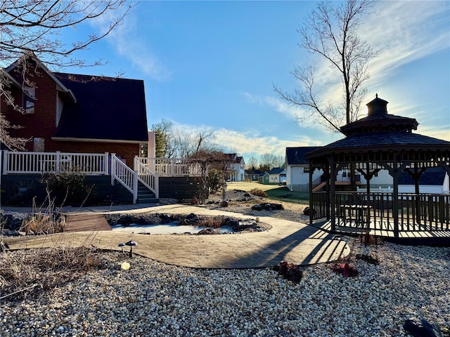 view of yard with a wooden deck and a gazebo