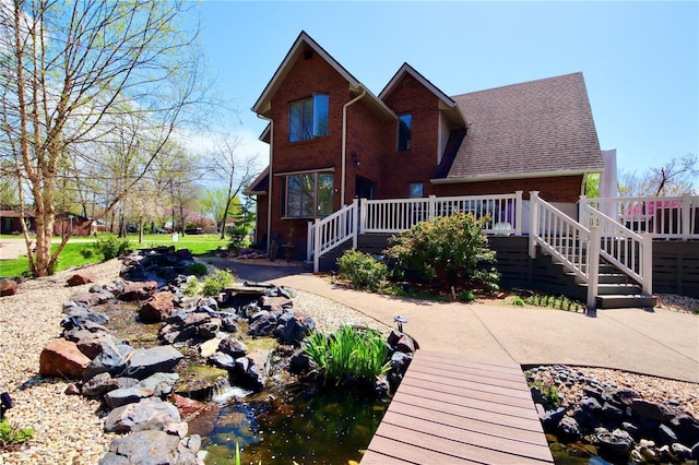 view of front of home with a deck and stairs