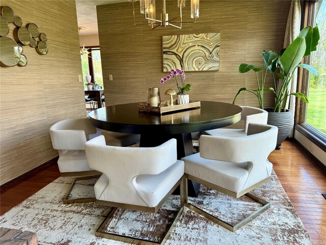 dining area featuring a notable chandelier and wood finished floors