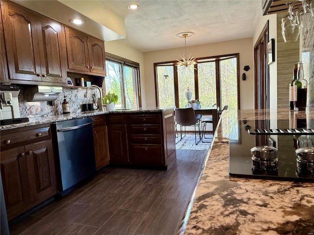 kitchen featuring an inviting chandelier, recessed lighting, light stone counters, dishwasher, and decorative backsplash