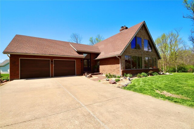 view of front of house with brick siding, an attached garage, a chimney, a shingled roof, and driveway