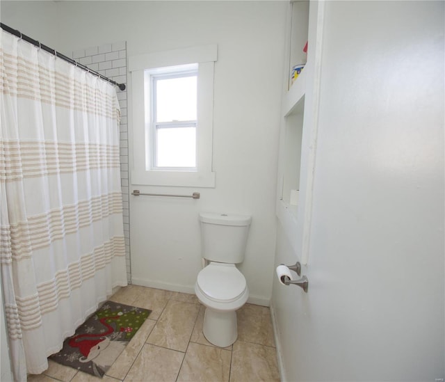 bathroom with tile patterned flooring and toilet