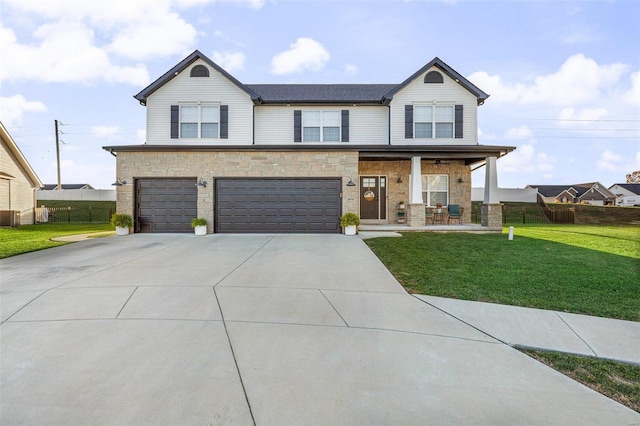 view of front of property featuring a garage, a front lawn, and covered porch