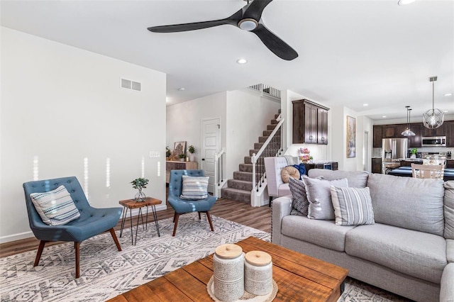 living room featuring hardwood / wood-style floors and ceiling fan