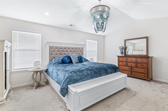 bedroom with vaulted ceiling, light carpet, and an inviting chandelier