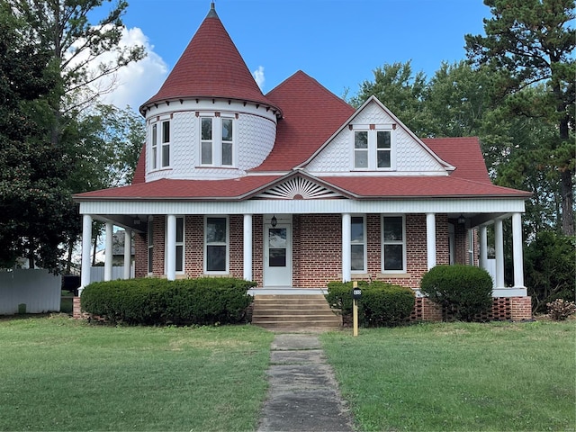 victorian home with a porch and a front lawn