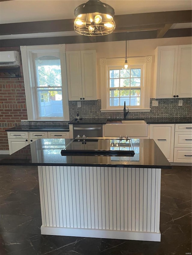 kitchen with stainless steel dishwasher, plenty of natural light, sink, and an AC wall unit