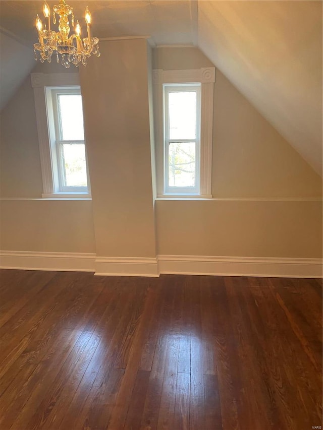 additional living space with vaulted ceiling and dark hardwood / wood-style flooring