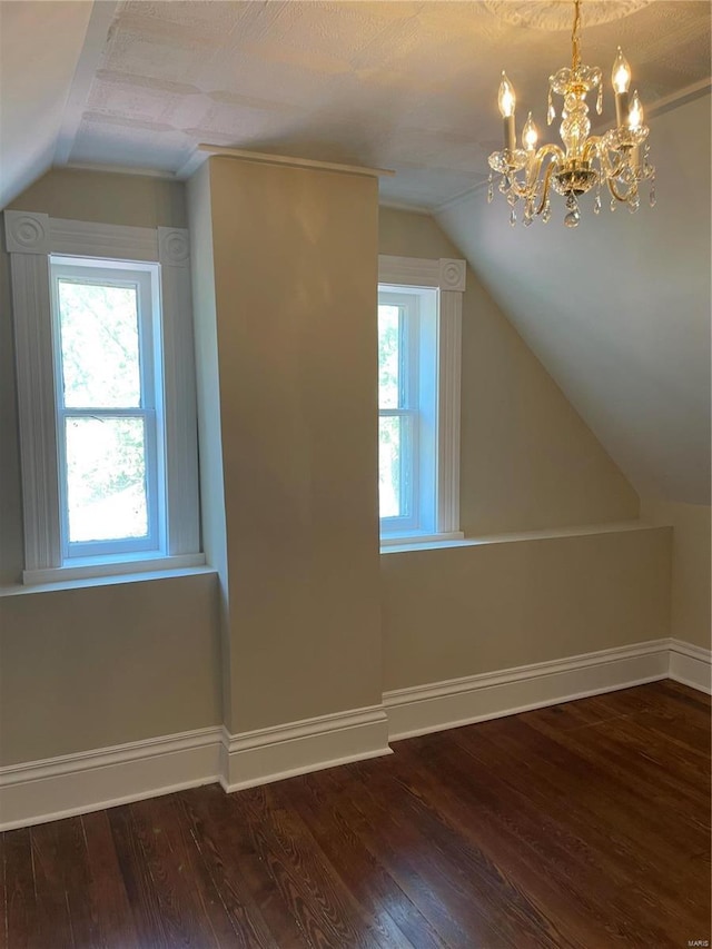 bonus room featuring lofted ceiling, dark hardwood / wood-style floors, and a textured ceiling